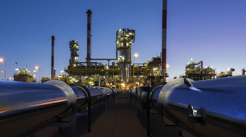 Photo of an oil refinery at twilight.