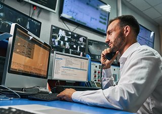 Man in a control room on phone