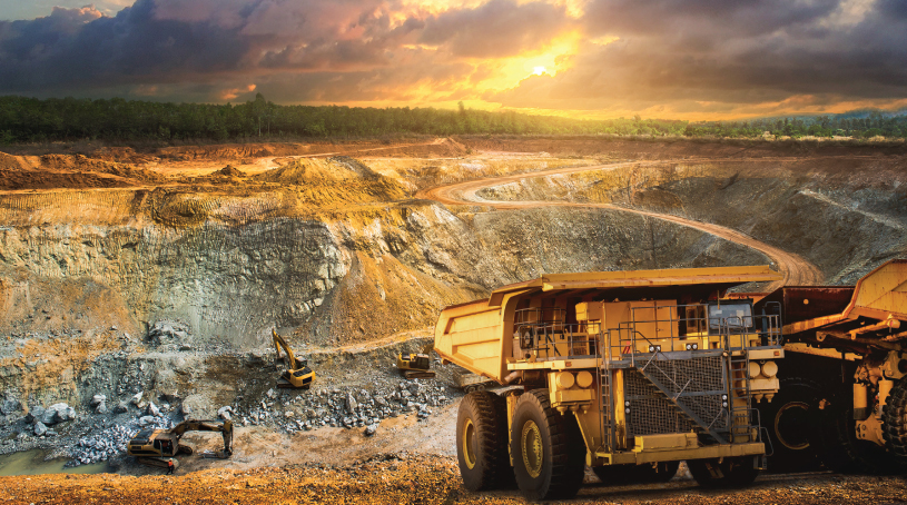 Large dump trucks at a vast mining site.